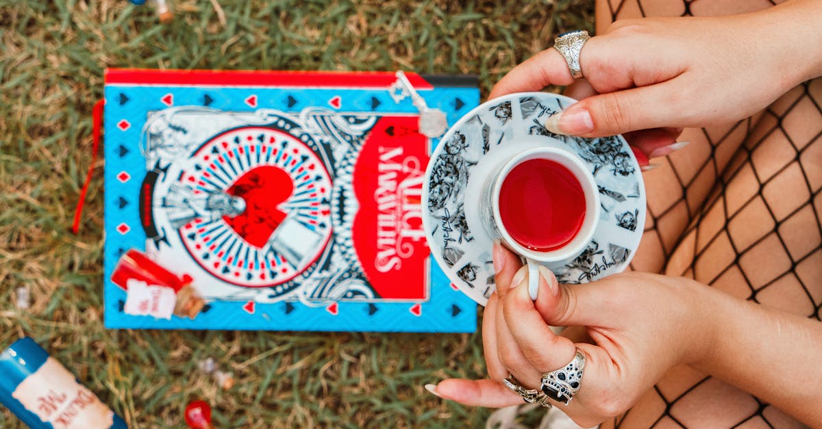 Tea party scene with Alice in Wonderland book and vibrant visuals, outdoors.